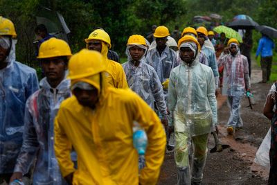 Indian rescuers recover 27 dead but no sign of dozens of missing villagers swamped by a landslide