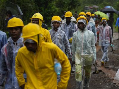 Indian rescuers find 27 dead and dozens are missing after rains cause landslide