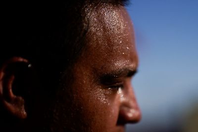 AP PHOTOS: People shade, hydrate and stay indoors in scorching heat on U.S.-Mexico border