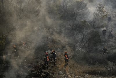 Wildfires in Greece prompt massive evacuations, leaving tourists in limbo