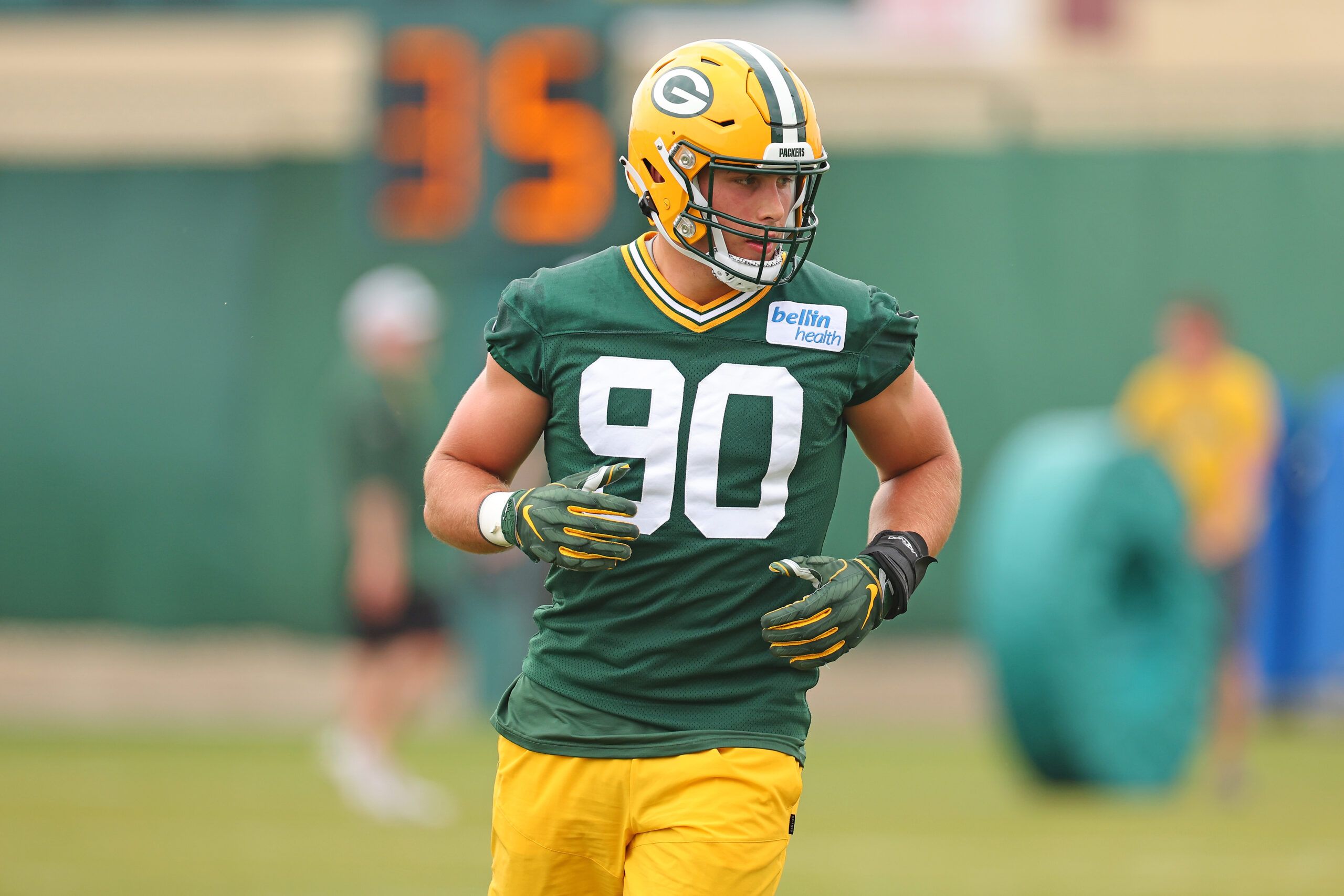 Green Bay Packers' T.J. Slaton runs a drill at the NFL football