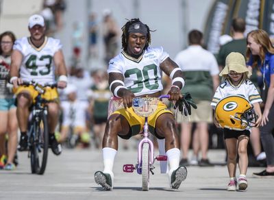 14 delightful photos of Packers riding kids’ bikes to training camp, which is the best tradition