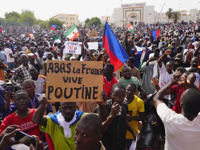 Supporters of Niger's coup march, waving Russian flags and denouncing France