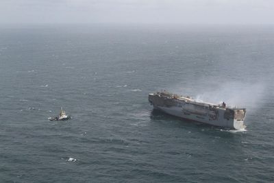 Tugs tow burning cargo ship to new location on North Sea while salvage crews ponder next steps