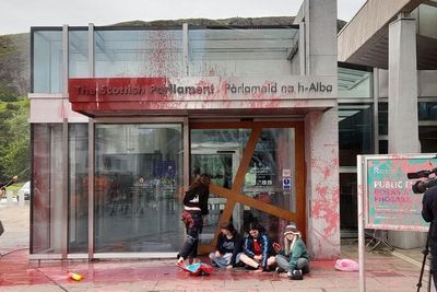 Climate activists spray Scottish Parliament building with red paint in oil protest