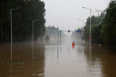 China floods threaten downstream cities as tens of thousands evacuated