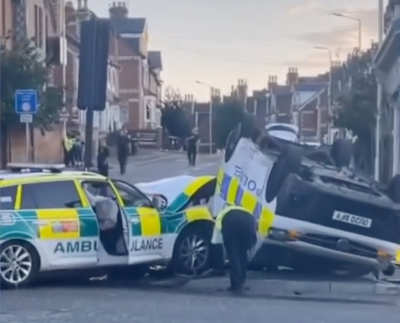 Officers injured as police van flips in crash with ambulance