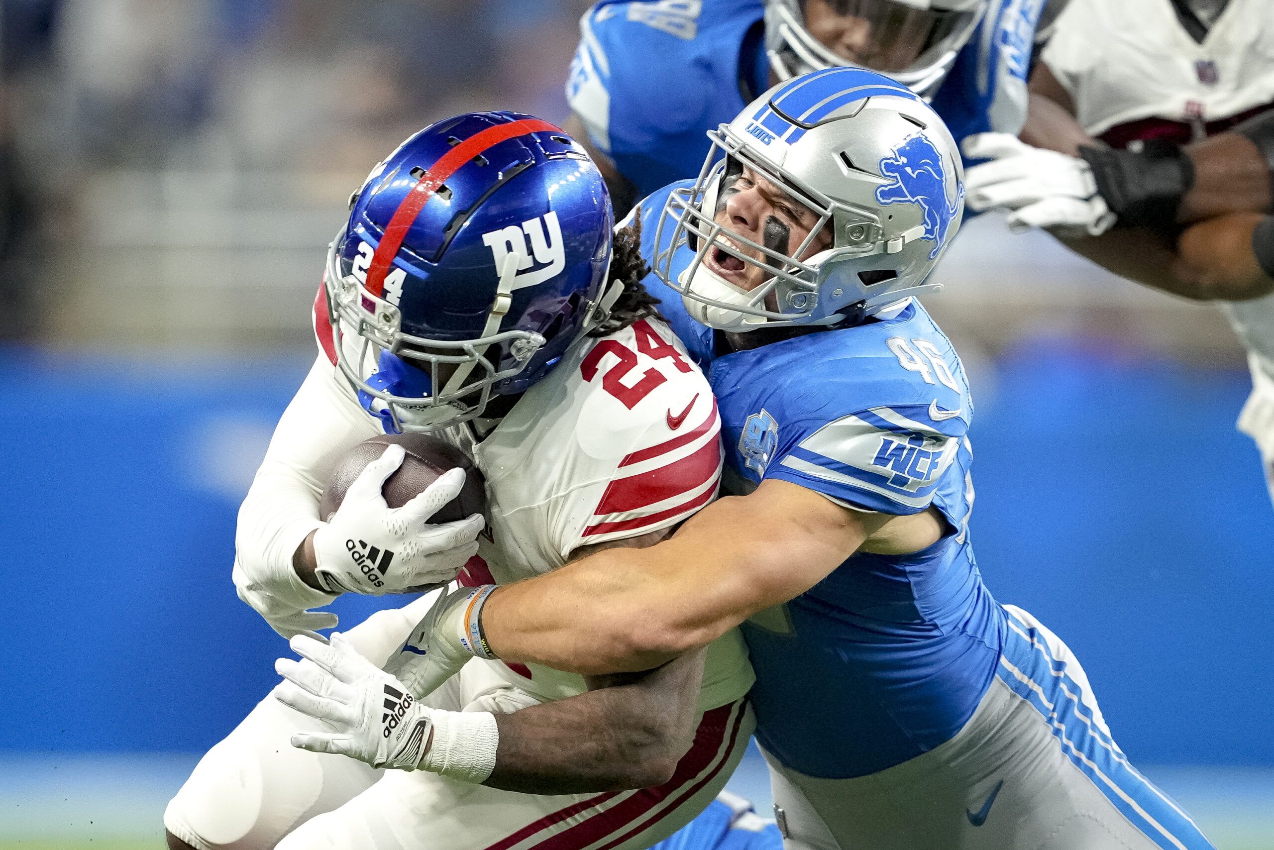 Detroit Lions quarterback Adrian Martinez (18) keeps the ball during the  second half of an NFL