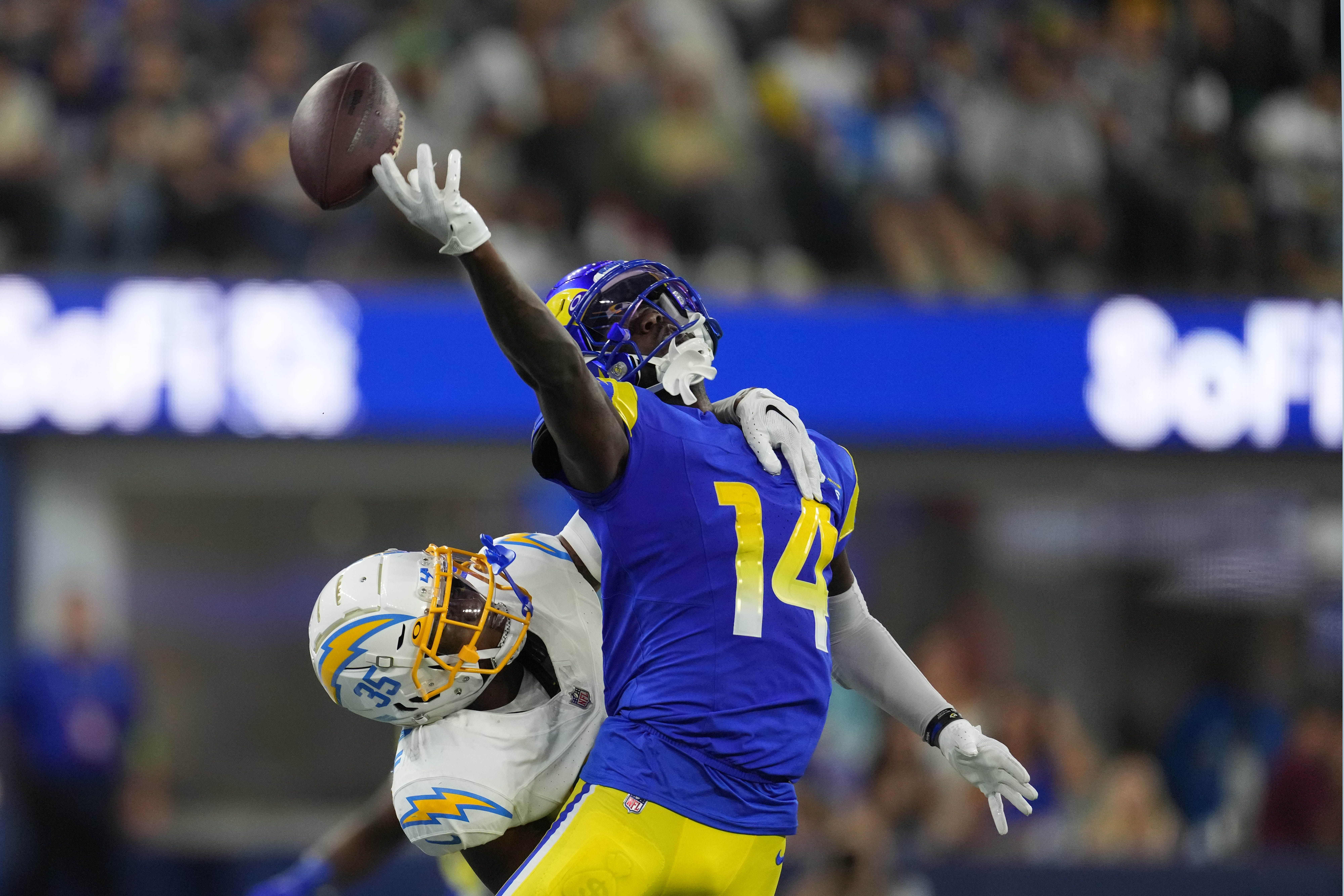 Los Angeles Rams wide receiver Tyler Johnson (14) reaches for the pass  while being held by Los Angeles Chargers cornerback AJ Uzodinma (35) in a  NFL preseason game. The Chargers defeated the