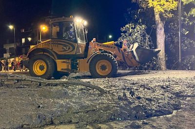 Crews search for possible missing after a mudslide in the Italian Alps coats city streets in muck