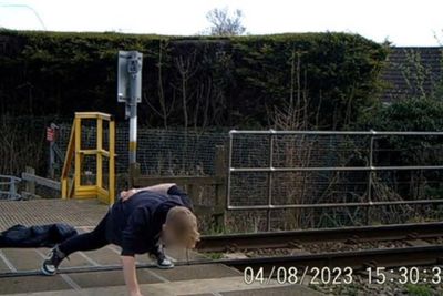 Safety warning after teenager seen doing one-armed press-up on level crossing