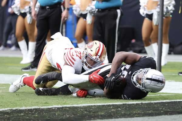 San Francisco 49ers safety Ji'Ayir Brown, left, tackles Las Vegas Raiders  running back Zamir White short of the goal line during the first half of an  NFL preseason football game, Sunday, Aug.