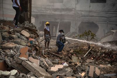 Dominican firefighters find more bodies as they fight blaze from this week's explosion; 13 killed