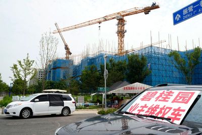 China's government tries to defuse economic fears after real estate developer's debt struggle