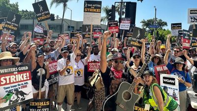 Tom Morello breaks out the Takamine and joins the Hollywood picket line as he plays Woody Guthrie for striking union members
