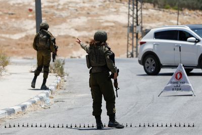 Two Israelis killed by suspected Palestinian gunman; manhunt under way