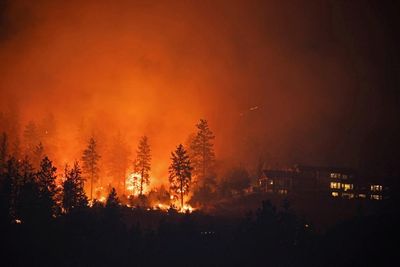 Canada wildfires: thousands told to flee in British Columbia, as drone-flying tourists criticised