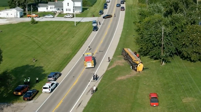 An Ohio school bus overturns after crash with minivan, leaving 1 child dead and 23 injured