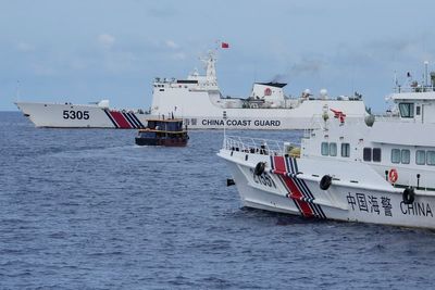 Chinese coast guard blocks Philippine vessels near disputed shoal but two supply boats breach cordon
