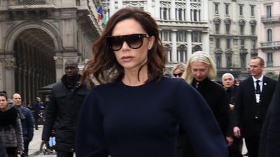 Victoria Beckham stuns in Italy in a long sleeve flowing white dress and brown leather Birkin bag