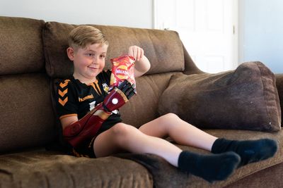 Boy who was born without a hand gets to grips with new ‘robot arm’