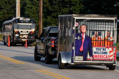 Scores of Trump supporters show support outside Georgia jail ahead of his expected surrender