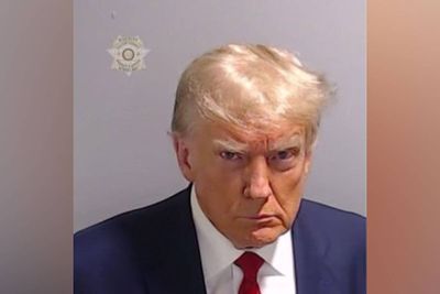 Trump scowls in historic mug shot after arrest at Fulton County Jail