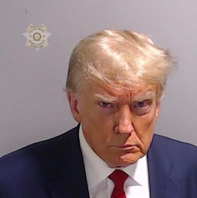 Belligerence and hostility: Trump’s mugshot defines modern US politics