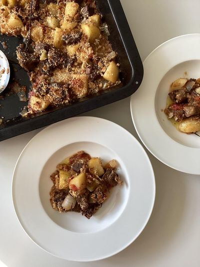 Rachel Roddy’s recipe for lamb with potato, tomato and breadcrumbs