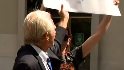 Peter Navarro tries and fails to rip up ‘Trump Lost’ sign in awkward press conference exchange