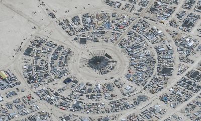 Burning Man festival-goers trapped in desert as rain turns site to mud