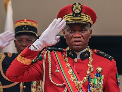 A Gabon military coup leader is sworn in as interim president, promising elections