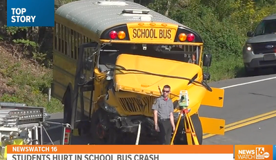 Dozens of students hospitalised after school bus crash with tow truck