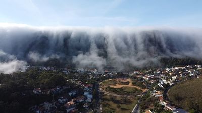 Wave of clouds appears to swallow city in spectacular drone footage