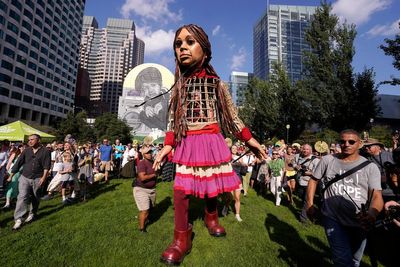 Little Amal, a 12-foot puppet of a Syrian refugee, began its journey across the US in Boston