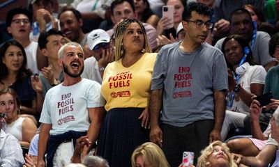 US Open semi-final interrupted as climate protester glues feet to floor in stands