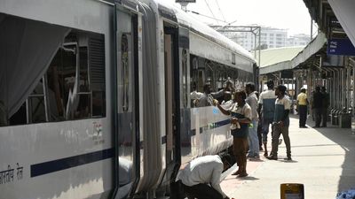 Railway staff hand over luggage that passenger left behind on Vande Bharat Express