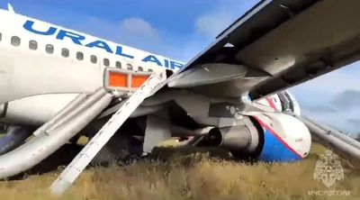 A Russian passenger jet with a hydraulics problem makes a safe emergency landing in an open field