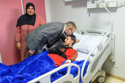 King of Morocco visits earthquake patients at Marrakech , kissing one on head and donating blood