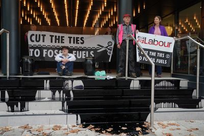 Extinction Rebellion pour fake oil over steps of Labour HQ