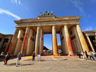 14 climate activists arrested for spray-painting Berlin’s iconic Brandenburg Gate bright orange