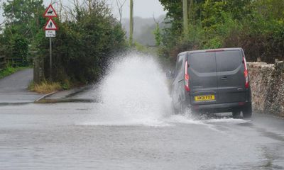 UK weather: power cuts and flooded roads as rain and wind hit