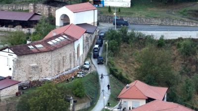 Kosovar police surround a village after gunmen storm a monastery