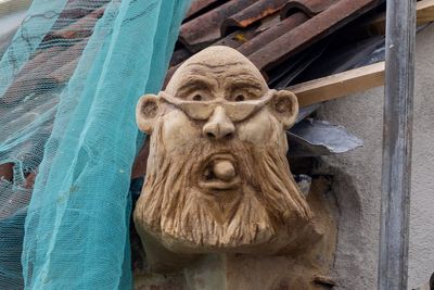 Angry builder puts gargoyle of council chief on home as planning row turns ugly