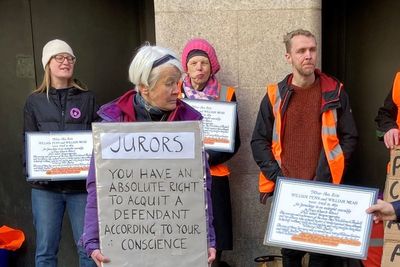 More than 250 climate activists protest with signs to jurors outside courts