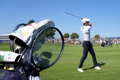 Novak Djokovic takes his tennis racket onto the 1st tee of golf's Ryder Cup All-Star match