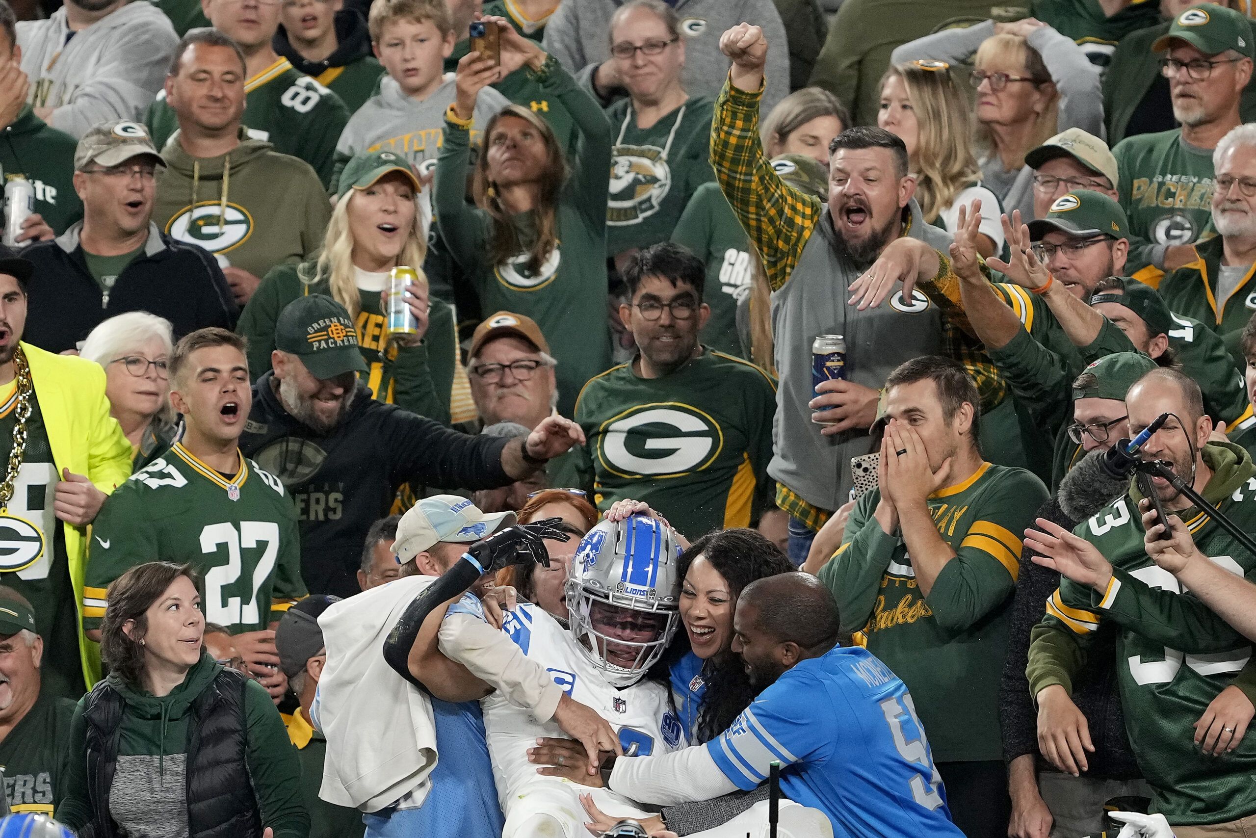 Packers fan caught by  TV cameras showering Lions star Amon-Ra St.  Brown with beer while he celebrated touchdown