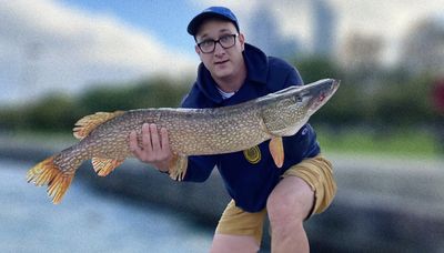 Fisher lands a big northern pike on the Chicago lakefront after several misses