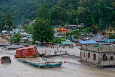 Flash floods kill at least 14 in northeastern India and leave more than 100 missing