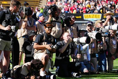 College football photographer takes tough shot … not with camera
